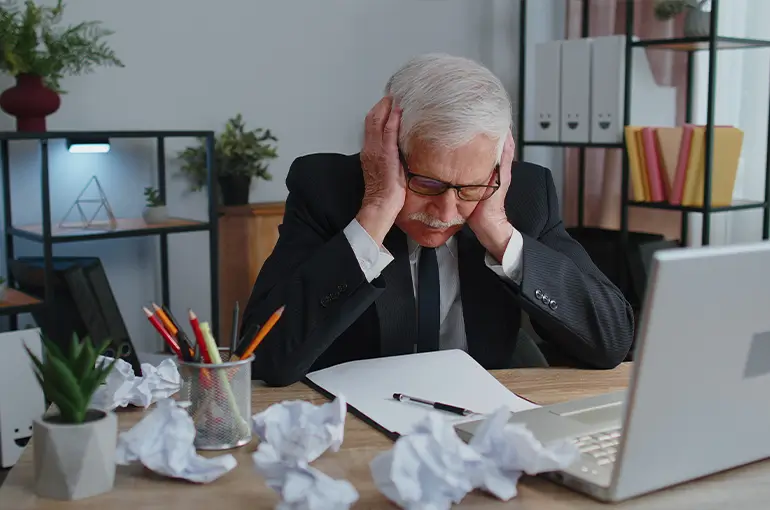 Jewelry business owner reviewing operational paperwork at his desk