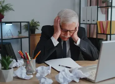 Jewelry business owner reviewing operational paperwork at his desk